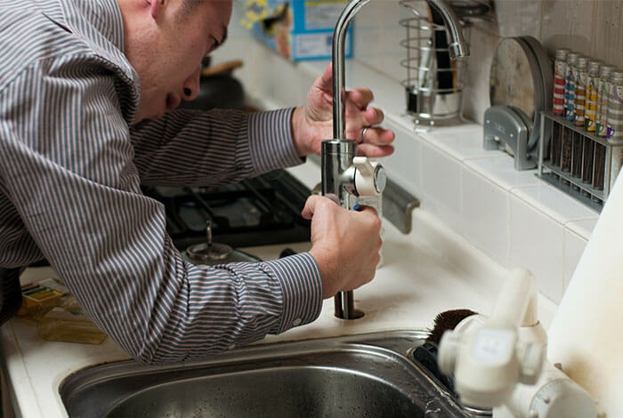 One of our plumbing engineers fixes a new sink unti for a commercial client